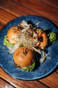 a blue plate with a sandwich on a table at Elements Hotel & Shops Curaçao in Willemstad