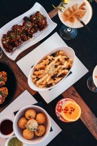 a table topped with plates of food and bowls of food at Elements Hotel & Shops Curaçao in Willemstad
