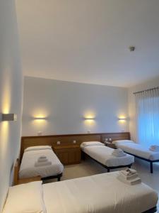 a hospital room with three beds in it at La Casa di Nazareth in Rome