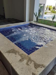 a swimming pool with blue tiles on the floor at Park Veredas Flat Service in Rio Quente