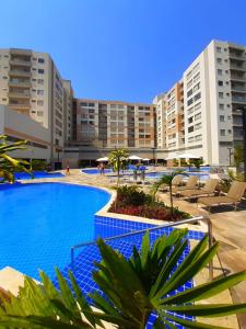 a resort with a large swimming pool and some buildings at Park Veredas Flat Service in Rio Quente