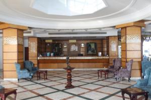 a lobby with chairs and a bar in a building at El Khan Sharm Hotel in Sharm El Sheikh