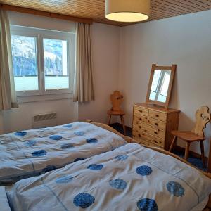 a bedroom with two beds and a mirror and a dresser at Chalet Waldrand in Inden