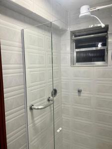 a shower with a glass door in a bathroom at Hotel Buriti da Serra in Itaipava