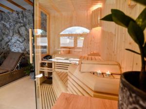 a room with a sauna with a couch and a table at Spa Oasis Samanta in Ludbreg