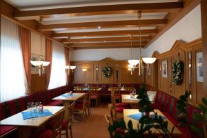 a dining room with tables and red chairs at Hotel Jägerhof in Bad Hersfeld