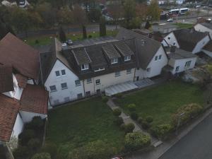 an aerial view of a white house with roofs at Hotel Jägerhof in Bad Hersfeld