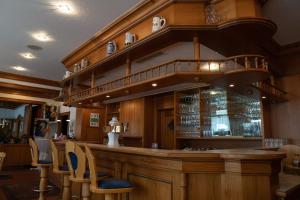 a bar in a restaurant with chairs around it at Hotel Jägerhof in Bad Hersfeld