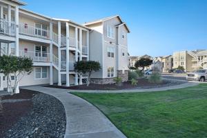 a apartment building with a sidewalk next to a street at Daydreaming in Westport