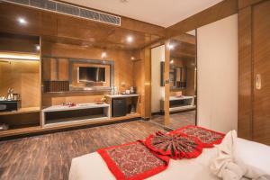 a bedroom with a large bed and a tv at Amritara Kirpa, Amritsar Golden Temple in Amritsar