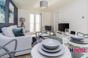 a living room with a glass table and chairs at Host Liverpool - Riverside Retreat by centre with private parking in Liverpool