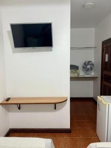 a flat screen tv on a wall in a room at Hotel Buriti da Serra in Itaipava