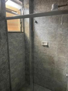 a shower with a glass door in a bathroom at Hotel Buriti da Serra in Itaipava