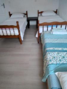 a room with three beds in a room at VILLA SIMKA in Kočani