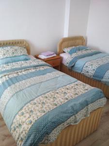 a room with two beds and two night stands at VILLA SIMKA in Kočani