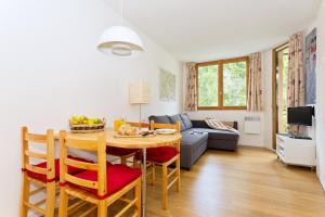 a kitchen and living room with a table and a couch at Apartment Chamois Blanc 2 in Chamonix