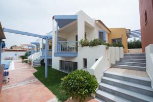 a view of a house with stairs and plants at Νηρηίδες Apartments Studios in Kyparissia