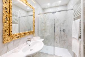 a bathroom with a sink and a mirror at Canal View San Marco Luxury Rooms in Venice