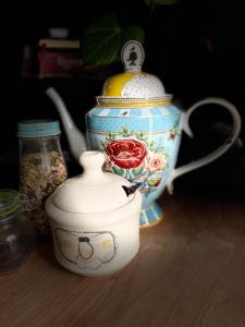 a blue and white tea pot sitting on a table at Silly's Inn in Middelburg