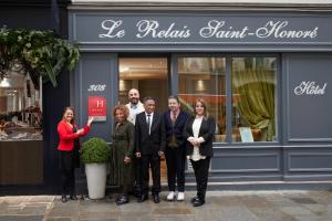a group of people standing in front of a store at Le Relais Saint Honoré in Paris