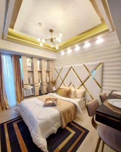 a bedroom with a large bed in a room at Royale at Azure North Bali Tower in San Fernando