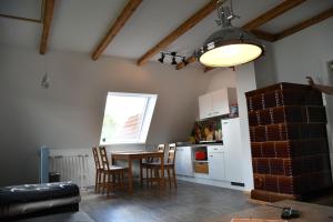 a kitchen with a table and chairs in a room at Balders Bude 2 in Mönkebude