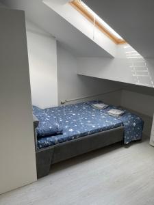 a bed in a room under a staircase at emaRooms16/27 in Soko Banja