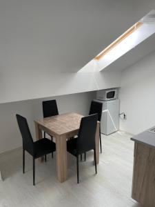 a table and chairs in a room with a kitchen at emaRooms16/27 in Soko Banja