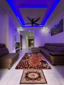 a living room with a couch and a ceiling fan at D’Alisya Homestay in Tawau