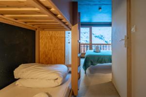 a bedroom with a bunk bed and a table at ho36 Les Menuires in Les Menuires