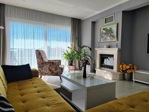 a living room with a couch and a fireplace at Luxury Apartment Pape in Baška Voda