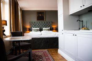 a hotel room with a bed and a table at Hotell Blanka- Lägenhet- Boutique Hotell in Varberg