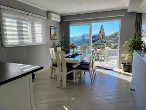 a kitchen and dining room with a table and chairs at Luxury Apartment Pape in Baška Voda