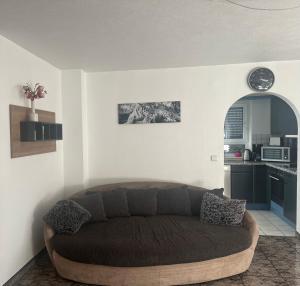 a living room with a brown couch in a kitchen at Angelina in Baiersbronn