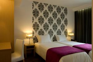 Postel nebo postele na pokoji v ubytování Hotel Genesis