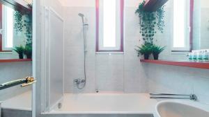 a bathroom with a shower and a tub and a sink at Italianway - Nona Strada 7 in Segrate +22 photos