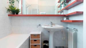 a bathroom with a sink and a bath tub at Italianway - Nona Strada 7 in Segrate