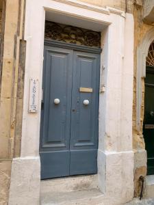 a blue door on the side of a building at DZC- Dazzle Den in Valletta
