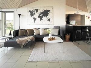 een woonkamer met een bank en een tafel bij 8 person holiday home in L kken in Løkken