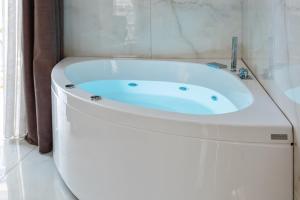 a white bath tub sitting in a bathroom at Partenope Relais in Naples
