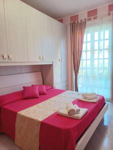 a bedroom with a large bed with towels on it at CasaEtnaMarty Acireale in Acireale