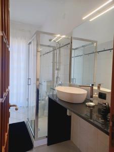 a bathroom with a sink and a glass shower at CasaEtnaMarty Acireale in Acireale