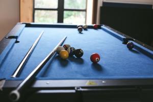 a pool table with balls and cues on it at Llanfair Hall, Dog Friendly, Cinema, Games Room, Hot Tub in Llanfairpwllgwyngyll