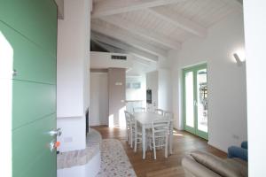 a living room and dining room with a table and chairs at Agriturismo San Filippo Neri in Castignano