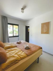 a bedroom with a large bed with towels on it at Seaside Apartment Corralejo : A cozy holiday home in a peaceful well located green complex in Corralejo