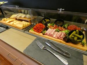 a buffet line with cheese and meats and vegetables at Limmathof Baden - Historisches Haus & Spa in Baden