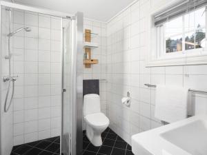 a white bathroom with a toilet and a shower at Smørøyet. Sentral beliggenhet på Geilo. in Geilo
