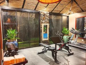 a room with a gym with exercise equipment in it at Mukwa River Lodge in Livingstone