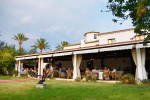 a group of people sitting at tables on a building at Hotel Tossal d'Altea in Altea