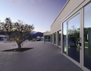 a building with a tree in the middle of a courtyard at Seven Park Hotel Lake Como - Adults Only in Colico